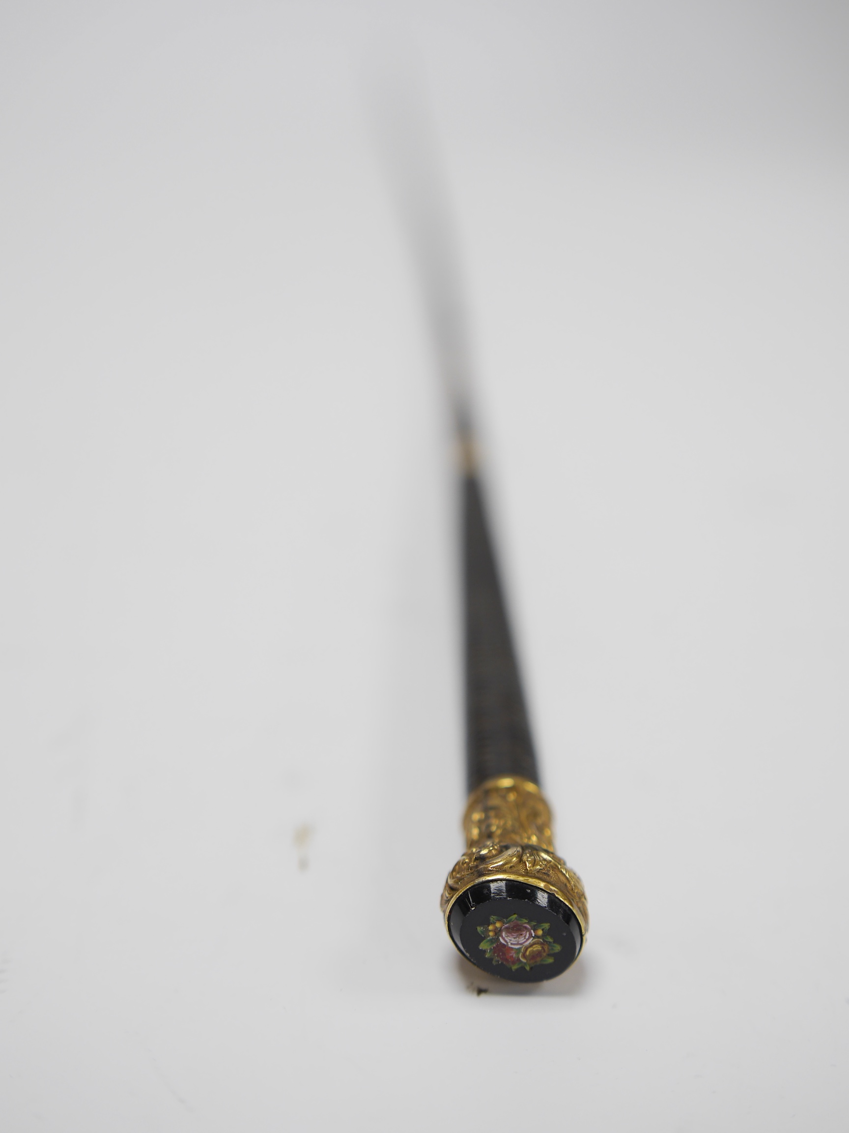 A gilt mounted whip with micro mosaic floral terminal, 78cm long. Condition - whip worn from use, terminal good